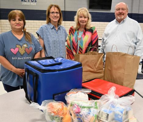 Partnering to help feed Altus children this summer, pictured with an array of packages for summer meals, including fruits and whole grain breads, left: Debbie Nunez, Altus summer feeding site supervisor; Sabina Garrett, child nutrition program director, Altus Public Schools; Kathy Hale, executive director of the Southern Prairie Library System; and Bruce Davis, coordinator of the Great Plains Literacy Council. Kevin Hilley | Altus Times