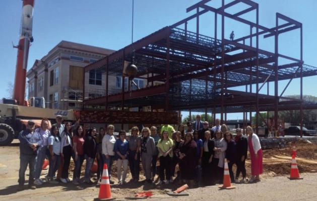Jackson County employees, members of the District III justice team, and contractors Joe D. Hall, Inc., pictured with the signed beam before it was put in place Kevin Hilley | Altus Times