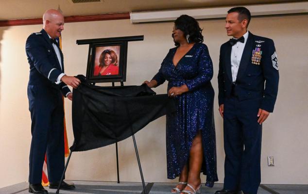 U.S. Air Force Col. Blaine Baker, 97th Air Mobility Wing commander (left) and Roberta Brady-Lee, vice mayor of Altus (right), unveil her portrait during the Friends of Altus induction at Altus Air Force Base, Oklahoma July 11, 2023. Brady-Lee has supported Altus Air Force Base Airmen as a keynote speaker focusing on diversity and inclusion. U.S. Airforce | Airman 1st Class Heidi Bucins