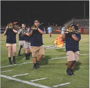 Band and Flag Corp take the field during homecoming