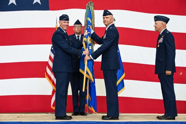 U.S. Air Force Maj. Gen. Clark Quinn, 19th Air Force commander, passes the 97th Air Mobility Wing (AMW) guidon to Col. Jeffrey Marshall, 97th Air Mobility Wing commander, during a change of command ceremony at Altus Air Force Base (AFB),Oklahoma, July 14, 2023. Marshall was previously stationed at Altus AFB as the Operations Support Squadron commander. See article on page 6. U.S. Air Force | Senior Airman Kayla Christenson