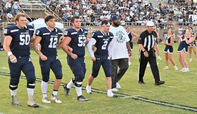 Dr. James Patterson, right, was presented as the Honorary Captain of the Altus Bulldogs at Friday’s opening home game. Also pictured were team captains from left, Grey Winsett, Garrett Gribble, Peyton Reed and Colton Gillispie. Kevin Hilley | Altus Times
